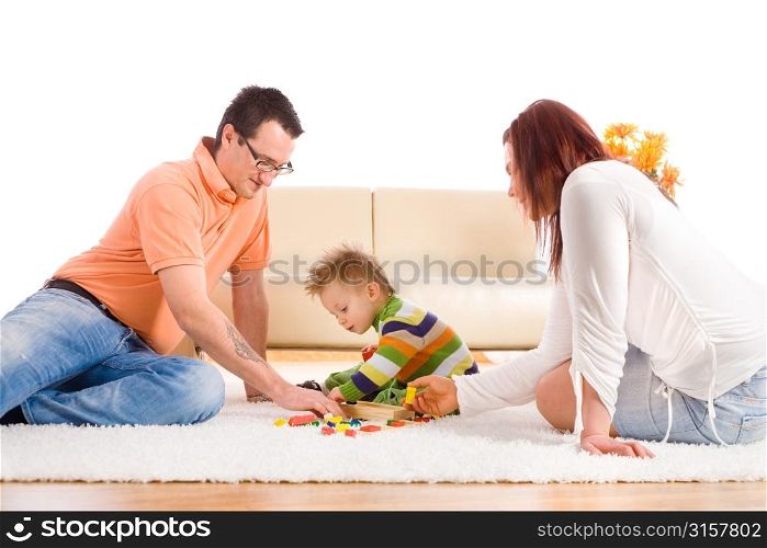 Parents and child playing on carpet