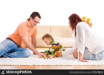 Parents and child playing on carpet