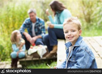 Parents And Children Having Picnic In Countryside