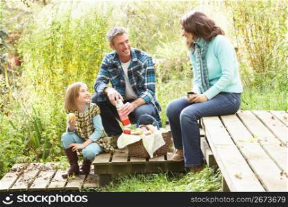 Parents And Children Having Picnic In Countryside
