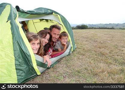 Parents and children in camp tent