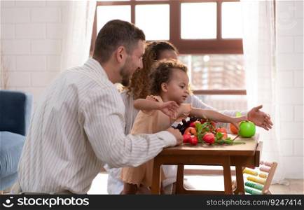 Parents and children relax in the living room of the house. Watch baby happily play with his favorite toy.