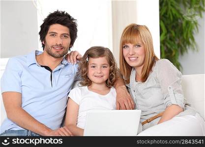 Parents and daughter sat on settee