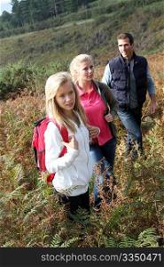 Parents and daughter walking in the countryside