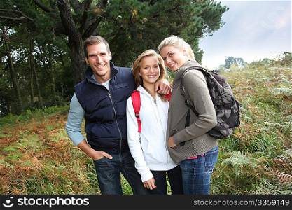Parents and daughter walking in the countryside