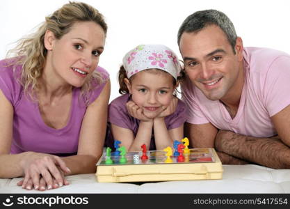 Parents and girl playing chess