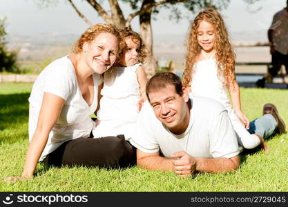 Parents and kids lying in the grass field