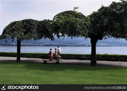 Parents and their two children walking in a park, Lindau, Germany