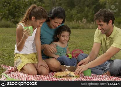 Parents and their two daughters looking at a hot dog