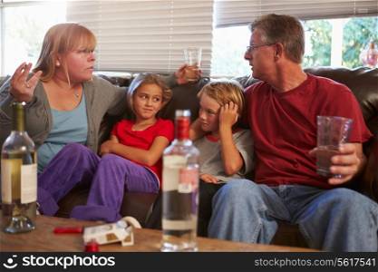 Parents Arguing On Sofa With Children Smoking And Drinking