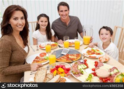 Parents Children Family Eating Pizza & Salad At Dining Table