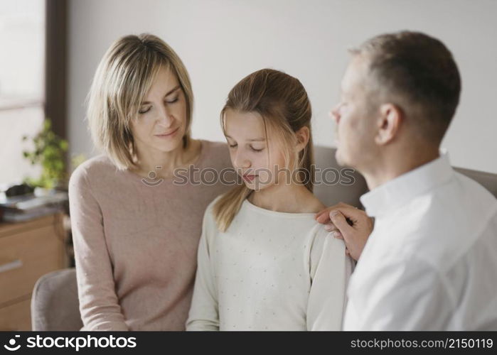 parents daughter praying together