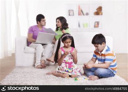Parents discussing while children play