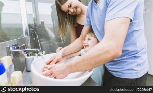parents girl washing hands
