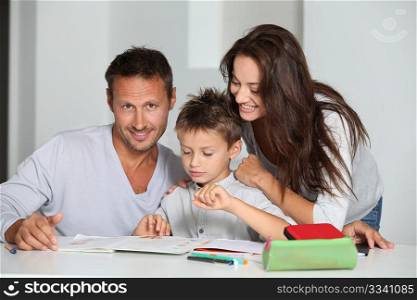 Parents helping son to do his homework