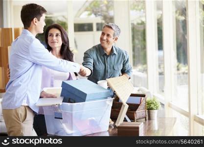 Parents Helping Teenage Son Pack For College