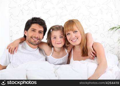 parents in bed with child