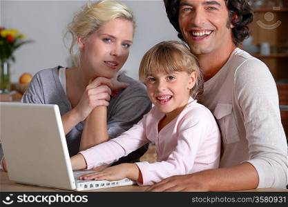parents initiating little girl to computer