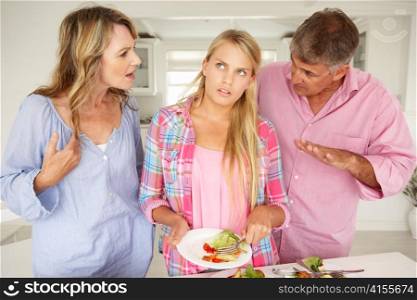 Parents making teenage daughter do chores at home