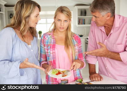 Parents making teenage daughter do chores at home