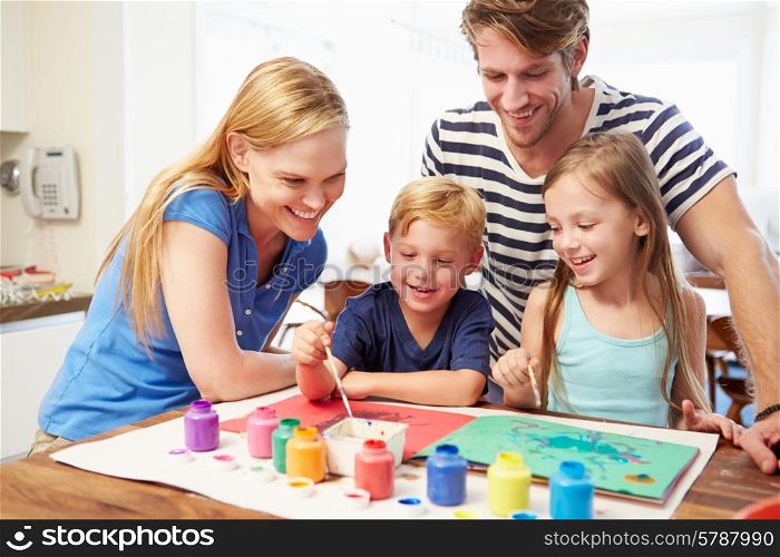 Parents Painting Picture With Children At Home