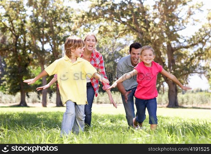 Parents playing with children in country