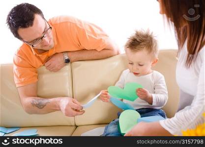 Parents playing with their child