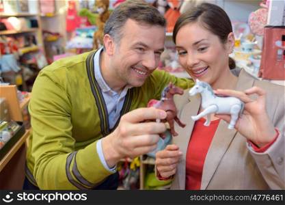 parents-to-be shopping choosing plush for their kid