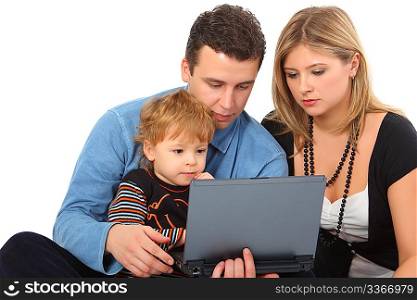 Parents whit son look in notebook