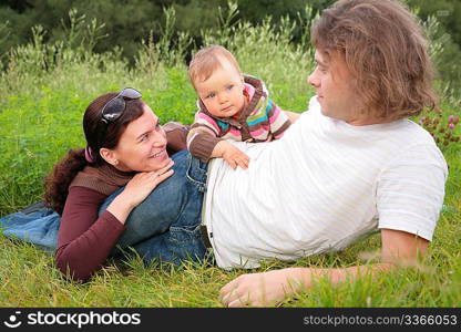 Parents with baby on nature lies