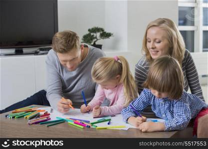 Parents with children drawing together at home