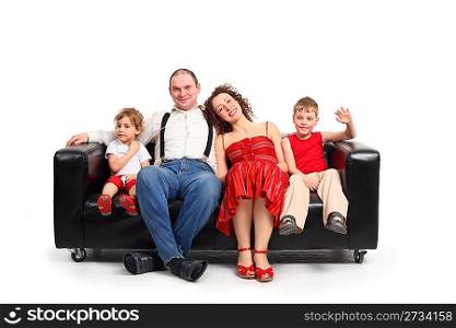 Parents with children sit on black leather sofa