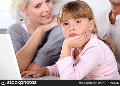 Parents with daughter and computer