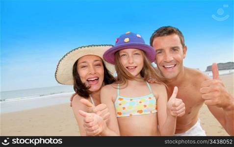 Parents with girl showing thumbs up