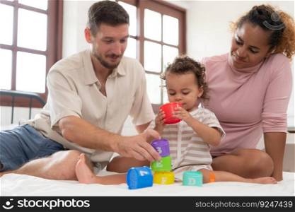Parents with little girl have fun playing with your new toys in the bedroom together. Toys that enhance children&rsquo;s thinking skills.