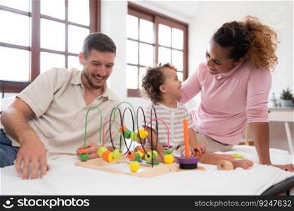 Parents with little girl have fun playing with your new toys in the bedroom together. Toys that enhance children’s thinking skills.