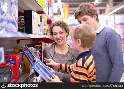 Parents with son in toy`s shop