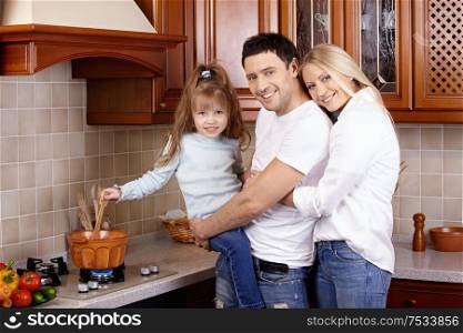 Parents with the child prepare at cooker