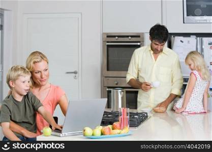 Parents with their children in the kitchen