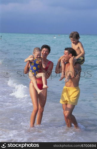 Parents with their son and daughter on the beach