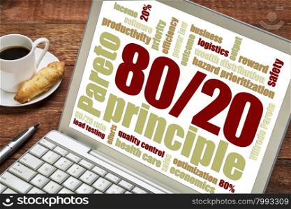 Pareto principle or eighty-twenty rule concept word cloud on a laptop with a cup of coffee