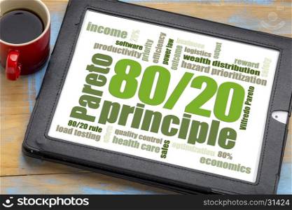 Pareto principle or eighty-twenty rule - word cloud on a digital tablet with a cup of coffee