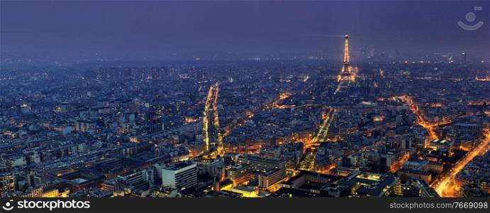PARIS - APRIL 5  Aerial panoramic view of Paris at night from Tour Montparnasse on April 5, 2013, in Paris, France. The Eiffel tower is the most visited touristic attraction in France.. Aerial panoramic view of Paris at night from Tour Montparnasse