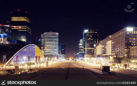 Paris city at night with business buildings and glass towers with lights, France. The city of Paris at night