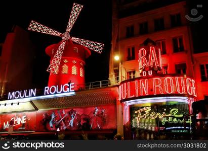 PARIS / FRANCE - 30 APRIL 2017: View of the Moulin Rouge (Red Mill) at night in Paris, a landmark cabaret in the Montmartre neighborhood of the French capital.. View of the Moulin Rouge (Red Mill) at night in Paris, France