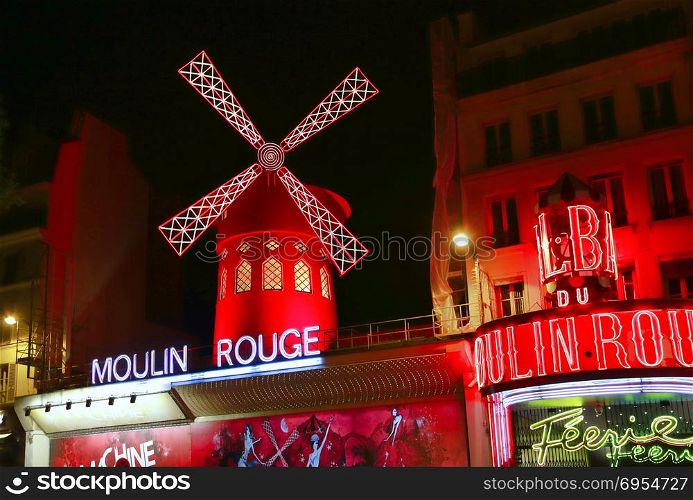 PARIS / FRANCE - 30 APRIL 2017: View of the Moulin Rouge (Red Mill) at night in Paris, a landmark cabaret in the Montmartre neighborhood of the French capital.