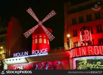PARIS / FRANCE - 30 APRIL 2017: View of the Moulin Rouge (Red Mill) at night in Paris, a landmark cabaret in the Montmartre neighborhood of the French capital.