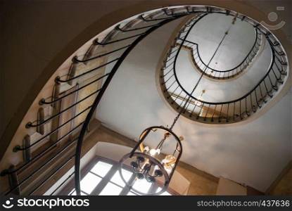 Paris, France - August 05, 2006: Bottom view of the spiral staircase in the gallery of Vivienne. Paris, France - August 05, 2006: Spiral staircase and vintage chandelier in the gallery of Vivienne. Paris