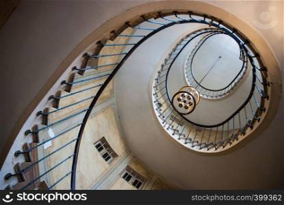 Paris, France - August 05, 2006: Spiral staircase and vintage chandelier in the gallery of Vivienne. Paris. Paris, France - August 05, 2006: Bottom view of the spiral staircase in the gallery of Vivienne