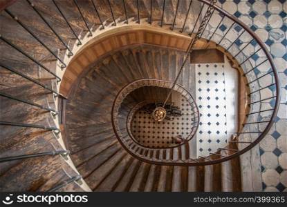 Paris, France - August 05, 2006: Top view of the architectural element of the spiral staircase in the gallery of Vivienne. Paris, France - August 05, 2006: Beautiful vintage high spiral staircase in the gallery of Vivienne. Top view